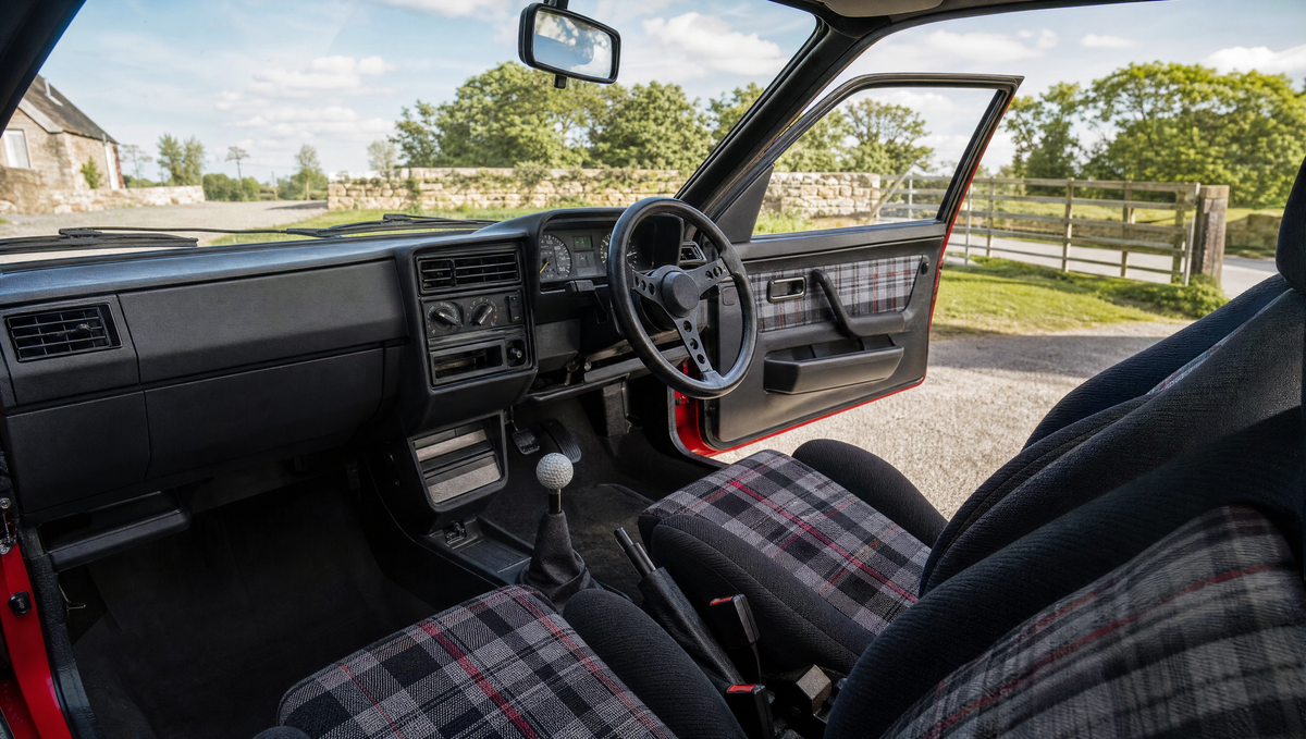 Small classic hatchback interior with plaid cloth seats