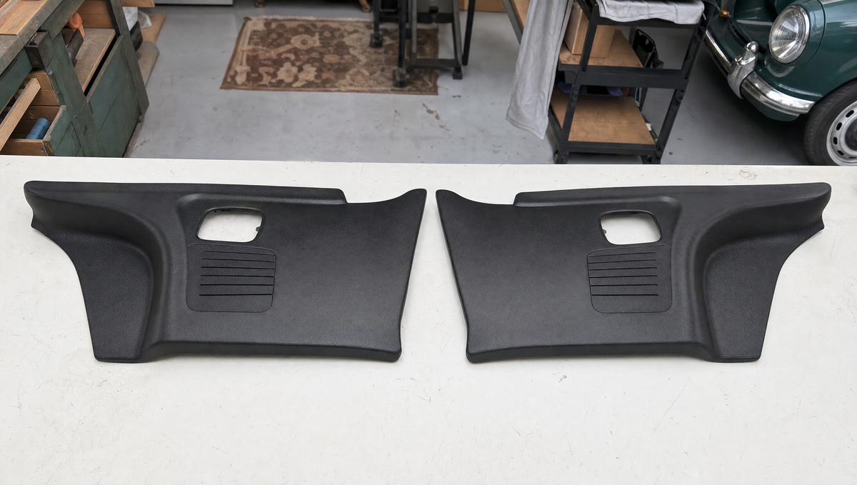 Left and right versions of a moulded interior trim panel side by side